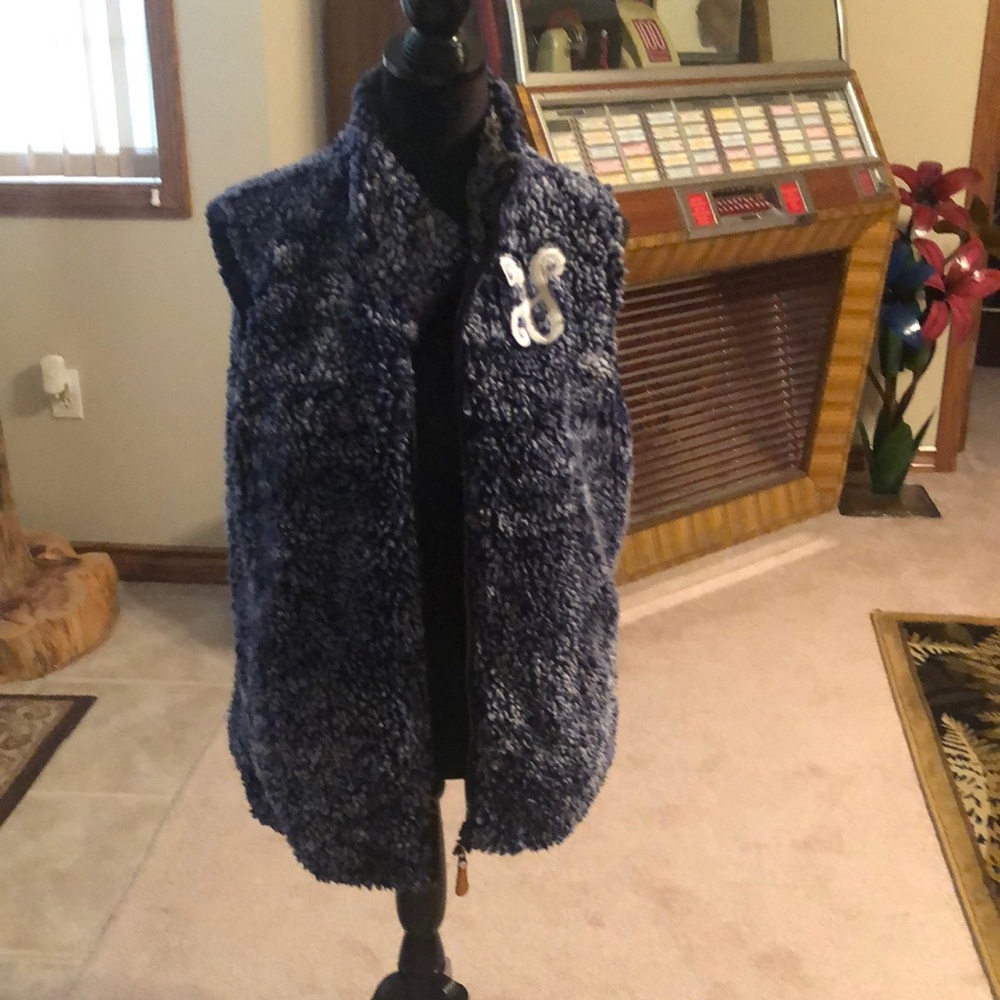 Fur vest with “v” initial
